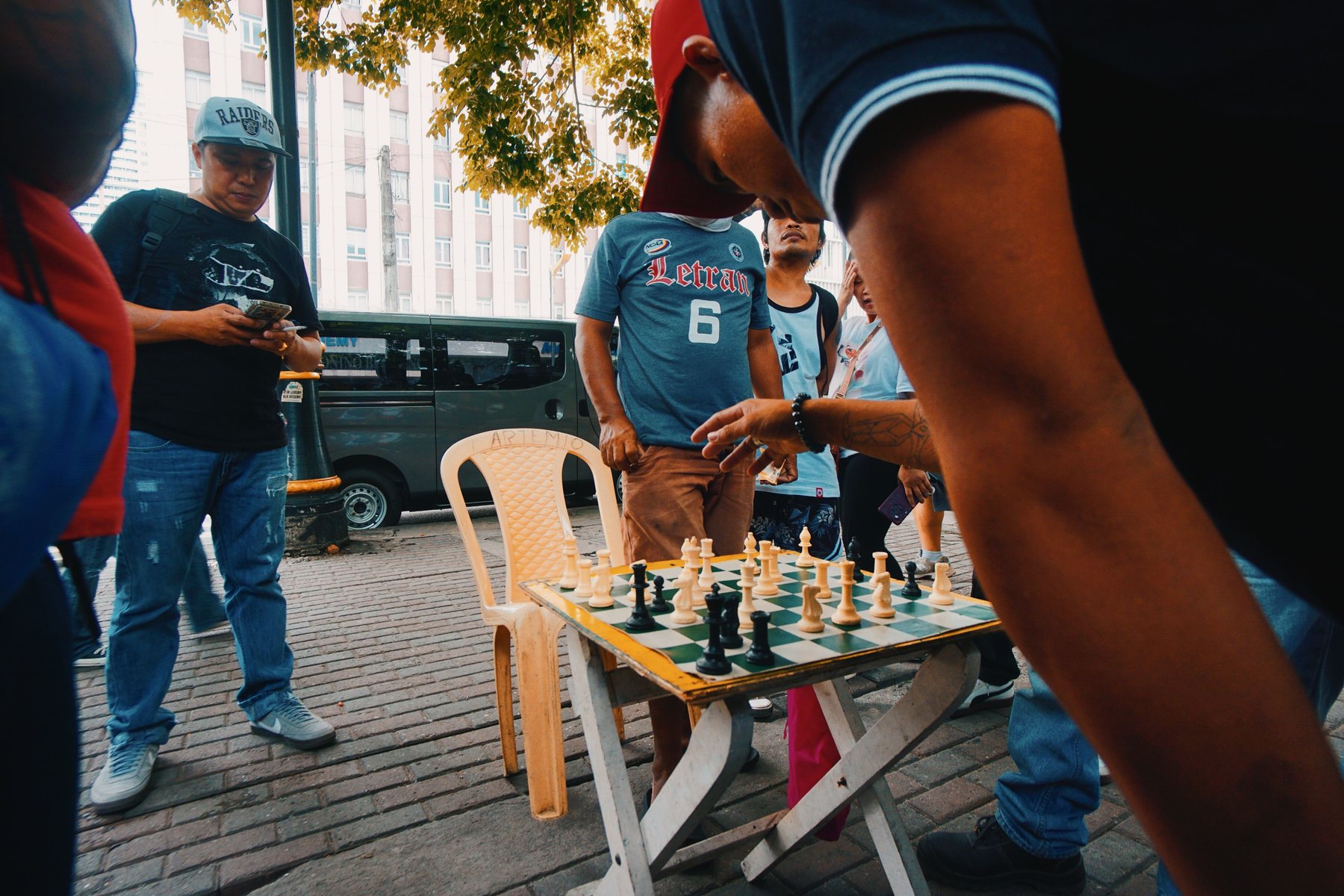 A crowd around a street chess game